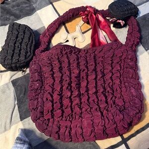 Burgundy puff hobo bag. Includes two smaller black bags. And two bag clips.